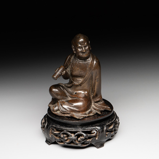 A small Chinese bronze figure of a Luohan, Ming