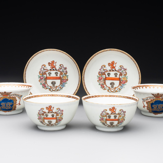 A pair of Chinese armorial famille rose cups and saucers with the arms of Tyndall for the English market and two monogrammed bowls, Qianlong