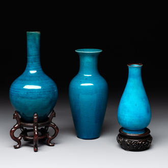 Three Chinese monochrome turquoise-glazed vases with two wooden stands, Kangxi and later