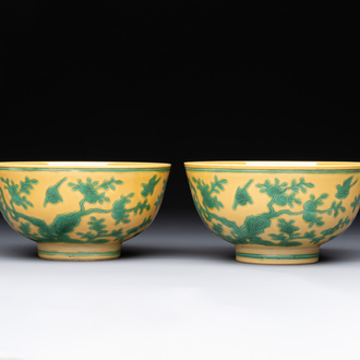A pair of Chinese yellow-ground 'peach and bird' bowls, Qianlong mark and probably of the period