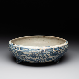 A Chinese Swatow blue and white crackle-glazed 'peonies and trigrams' tripod censer, Ming