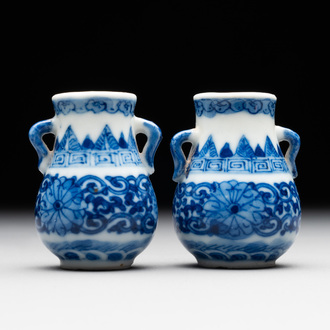 A pair of Chinese blue and white miniature 'hu' vases on wooden stands, Kangxi mark, 19th C.