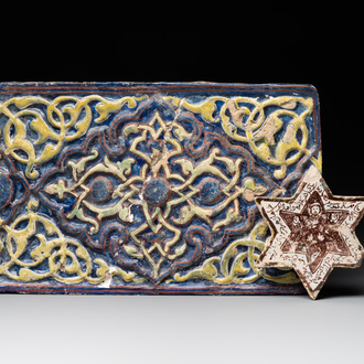 An Kashan lustre-glazed star tile and a rectangular moulded ornamental tile, Persia, 13/14th C.