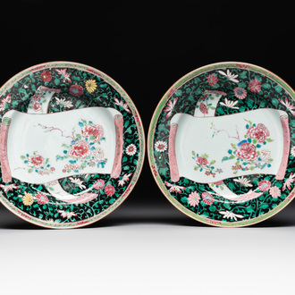 A pair of Chinese famille rose black-ground 'flowers and scrolls' plates, Yongzheng/Qianlong