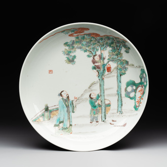 A Chinese famille verte dish with a sage and two boys under a tree, Shizhu 石竹 seal mark, Yongzheng