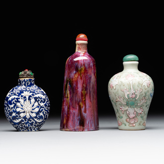 Two Chinese famille rose 'lotus scroll' snuff bottles and a flambé-glazed snuff bottle, 19th C.