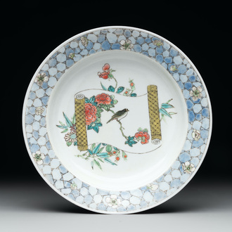 A fine Chinese famille rose 'ruby back' plate with a bird on a blossoming branch, Yongzheng