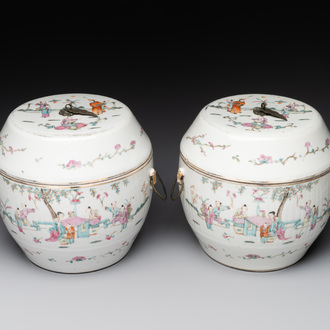 A pair of Chinese famille rose jars and covers with figures in a garden, Tongzhi mark and of the period