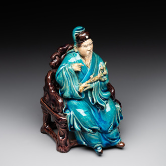 A Chinese turquoise- and aubergine-glazed sculpture of a seated scholar, 18/19th C.