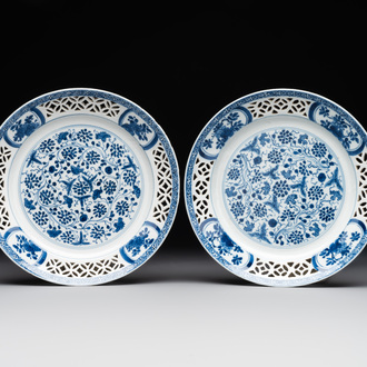 A pair of Chinese blue and white plates with floral design and reticulated border, conical shell mark, Kangxi