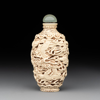 A Chinese moulded cream-glazed 'dragon and phoenix' snuff bottle, Jiaqing mark, 19th C.