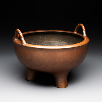 A large Chinese bronze tripod censer with two handles, 19th C.
