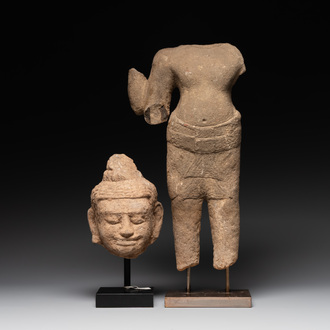 A sandstone torso and a Buddha head, Cambodia, late Khmer period, 13/14th C.