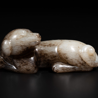 A Chinese partly black coloured white jade dog carving, Qing