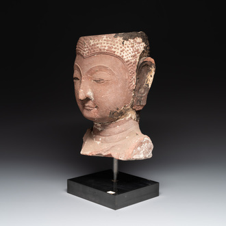 A Thai red sandstone head of Buddha, possibly Ayutthaya period, 15th C.