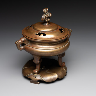 A Chinese bronze tripod censer with cover and stand, 19th C.