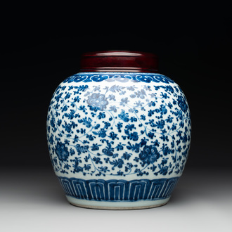 A Chinese blue and white 'flower scroll' jar with a wooden cover, Qianlong
