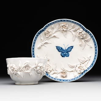 A Chinese blue and white 'butterfly' cup and saucer with applied floral design, Qianlong