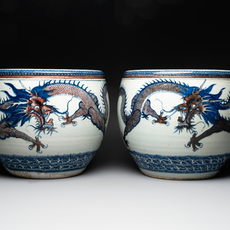 A pair of Chinese blue, white and copper-red 'dragon' fish bowls, Qianlong