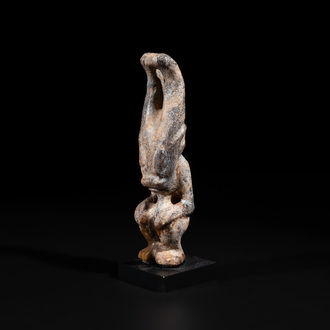 A Chinese jade carving of a crouched figure, possibly Hongshan culture