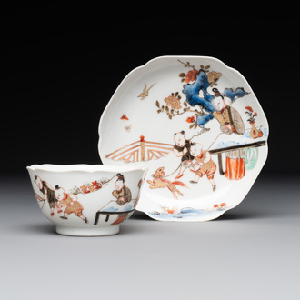 A Chinese polychrome cup and saucer with figures and a dog, Yongzheng