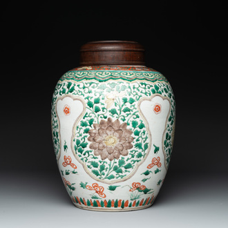 A Chinese famille verte jar with floral design and a wooden cover, Kangxi