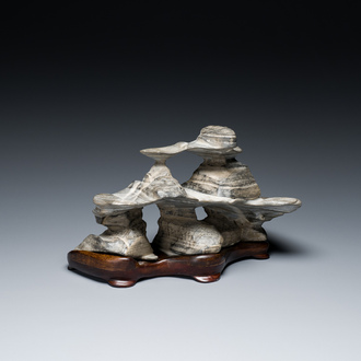 A Chinese grey Lingbi stone scholar's rock on wooden stand, 20th C.