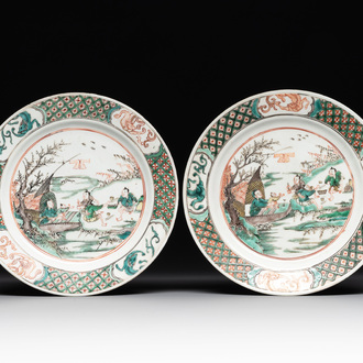 A pair of Chinese famille verte plates with figures along the riverside, artemisia leaf and ding mark, Kangxi