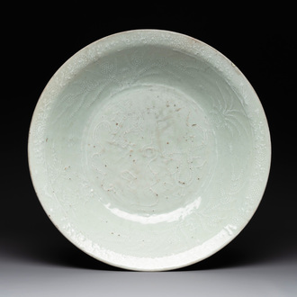 A rare Chinese Swatow slip-decorated pale-green-glazed 'dragon' dish, Ming