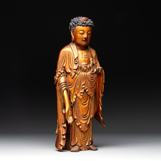 A fine Chinese gilt-lacquered wooden figure of the standing Buddha, Ming