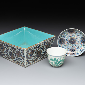 A Chinese gilt-decorated blue and white 'lotus scroll' square bowl, a saucer and a doucai 'dragon' cup, Daoguang mark and of the period