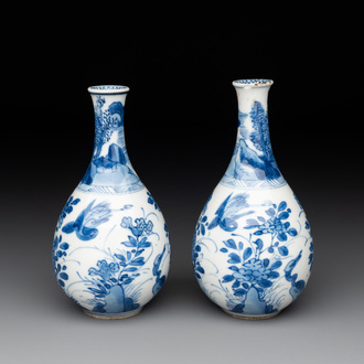 A pair of Chinese blue and white pear-shaped vases with cranes among flowering branches, Kangxi