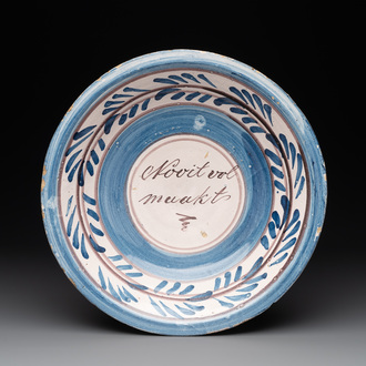 A proverbial blue, white and manganese dish, Makkum, Friesland, 1st half 19th C.