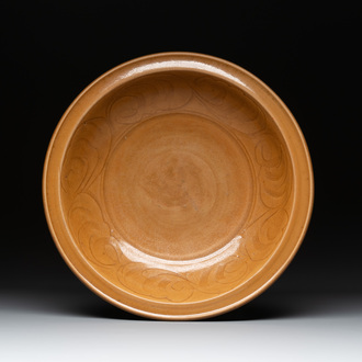 A Chinese incised brown-glazed Longquan dish with floral design, Ming