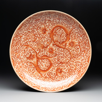 A Chinese iron-red-decorated crackle-glazed  'chilong and lotus scroll' plate, Jiajing mark, 19th C.