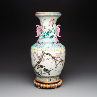 A Chinese famille rose 'magpies and plum blossoms' vase on wooden stand, 19th C.