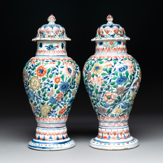 A pair of Chinese famille verte vases and covers with floral design, Kangxi