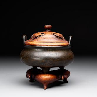 A Chinese bronze tripod censer with wooden cover and stand, Xuande mark, 18/19th C.