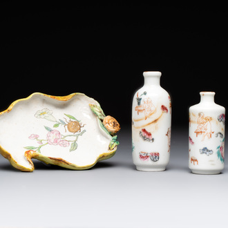 Two Chinese famille rose 'erotic' snuff bottles and a leaf-shaped saucer, 19th C.