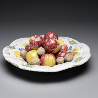 A rare polychrome Dutch Delft trompe-l'oeil dish with apples and walnuts, 17th C.