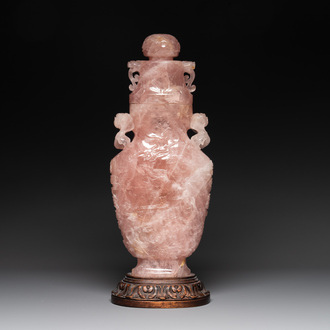 A large Chinese rose quartz vase and cover on a wooden stand, 20th C.