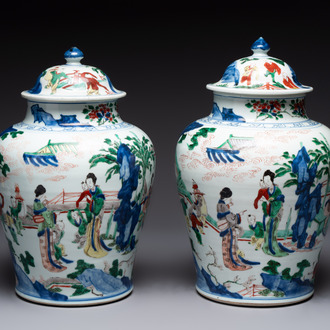 A pair of Chinese wucai vases and covers with court ladies and playing boys, Transitional period