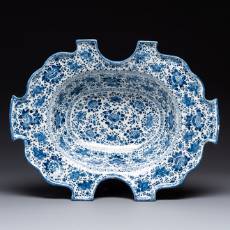 A very rare and large blue and white Dutch Delft double barber's bowl with floral design, late 17th C.