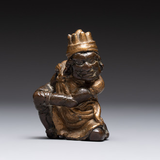 A small Chinese gilt bronze paperweight in the form of a kneeling foreigner, Ming