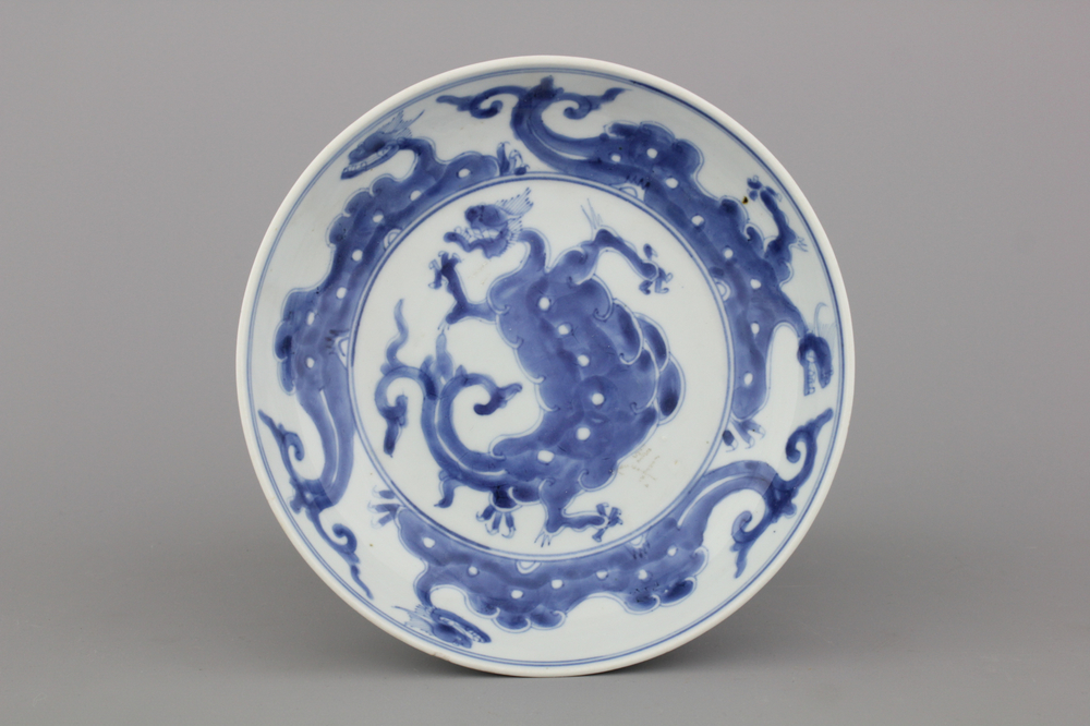 A Chinese porcelain blue and white dragon plate, 18th C.