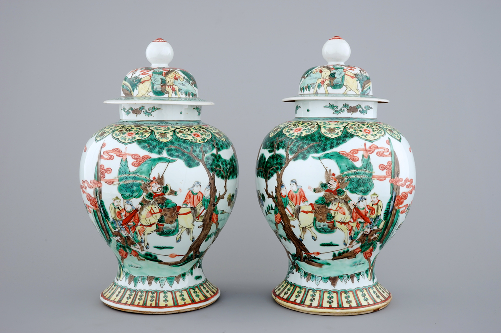 A pair of Chinese wucai porcelain warrior vases with covers, 19/20th C.