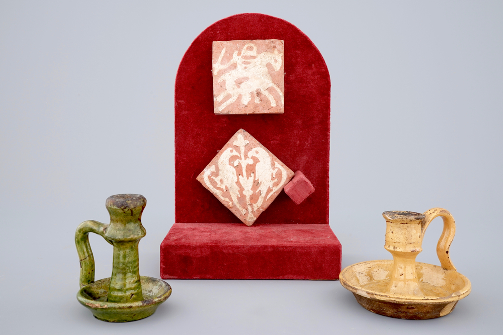 Two medieval tiles and two late medieval candlesticks, 16/17th C.