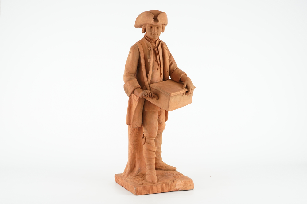 A tall terracotta figure of a hurdy-gurdy player, early 19th C.