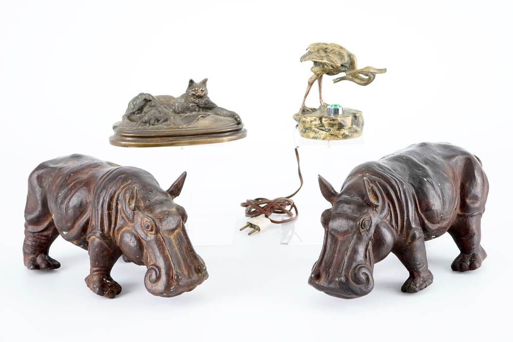 A group of bronze and regule animals: a group of cats, two hippos and a crane, 20th C.