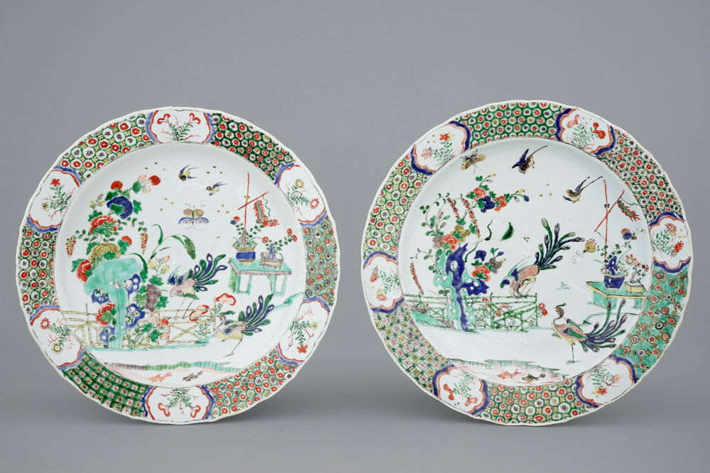 A pair of Chinese famille verte dishes with peacocks in a garden, Kangxi